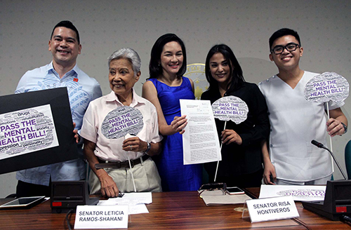Senator Risa Hontiveros (center) holds a copy of the proposed Mental Health Bll of 2016. Also in the photo is Raymond Naguit (far right) from the Faculty of Medicine and Surgery.